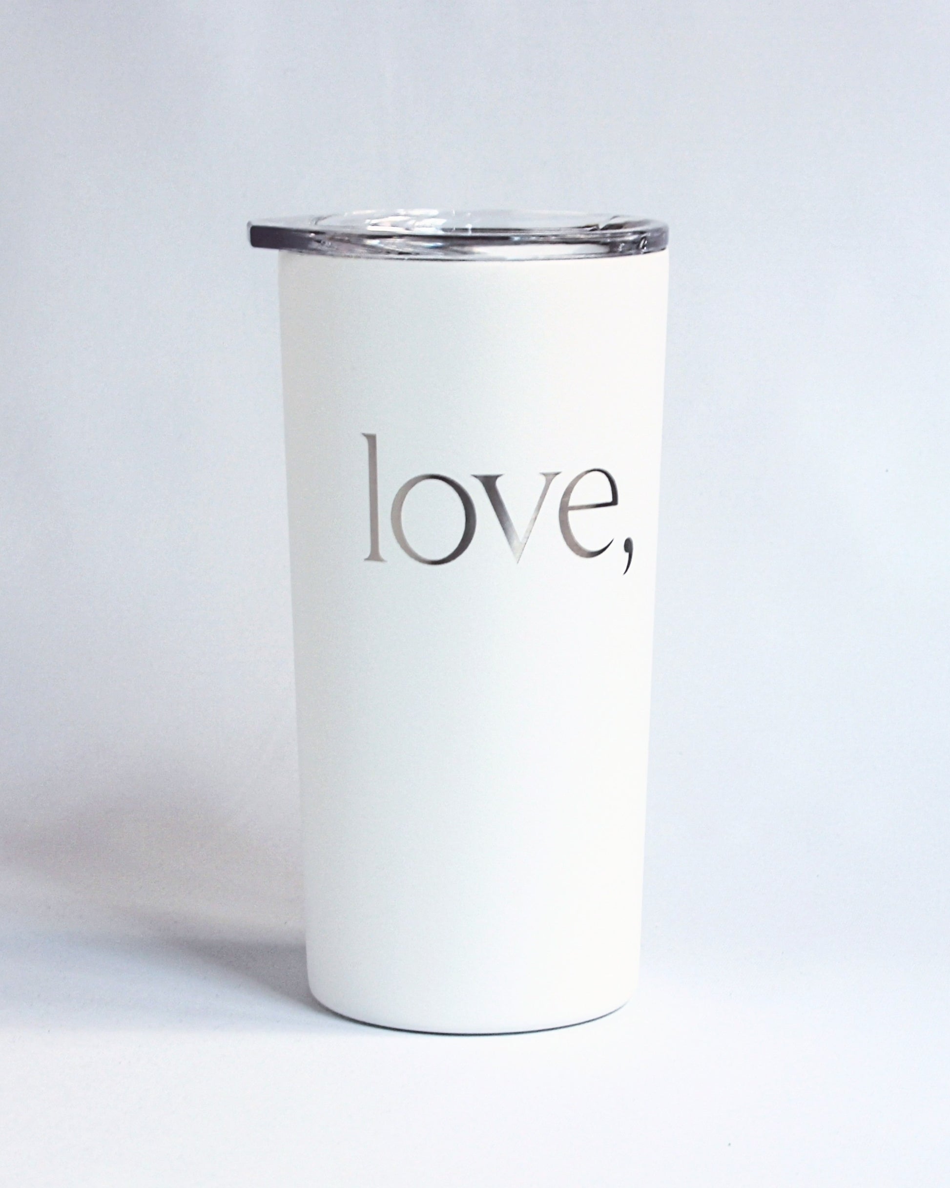 White tumbler with 'love' text on a light gray background