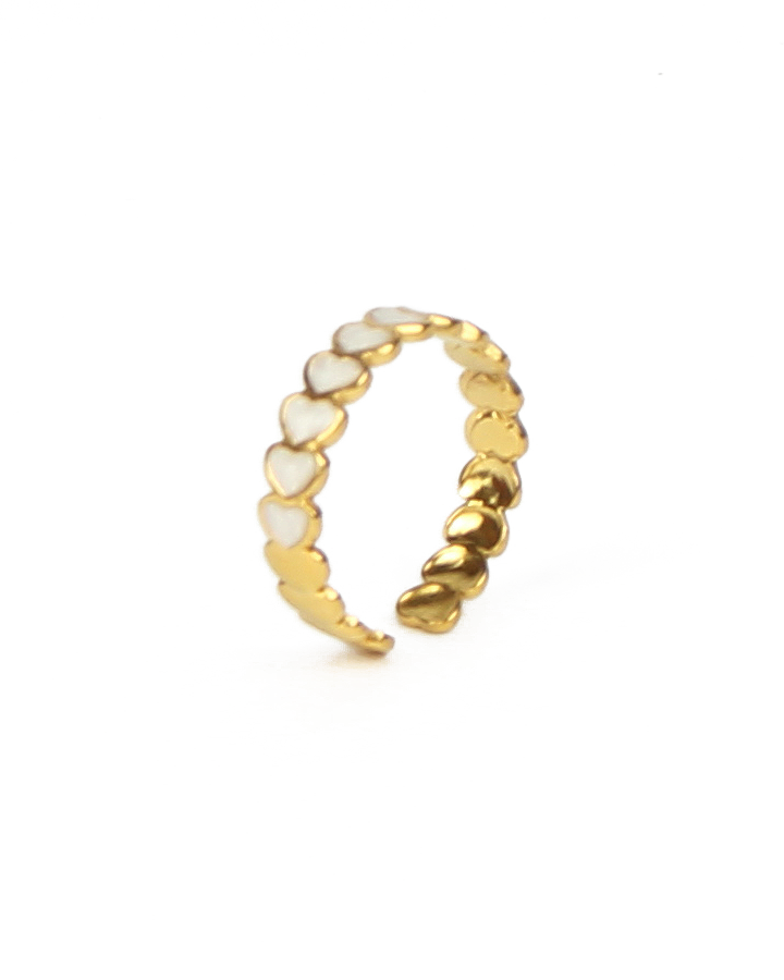 Gold ring with heart-shaped enamel on a white background