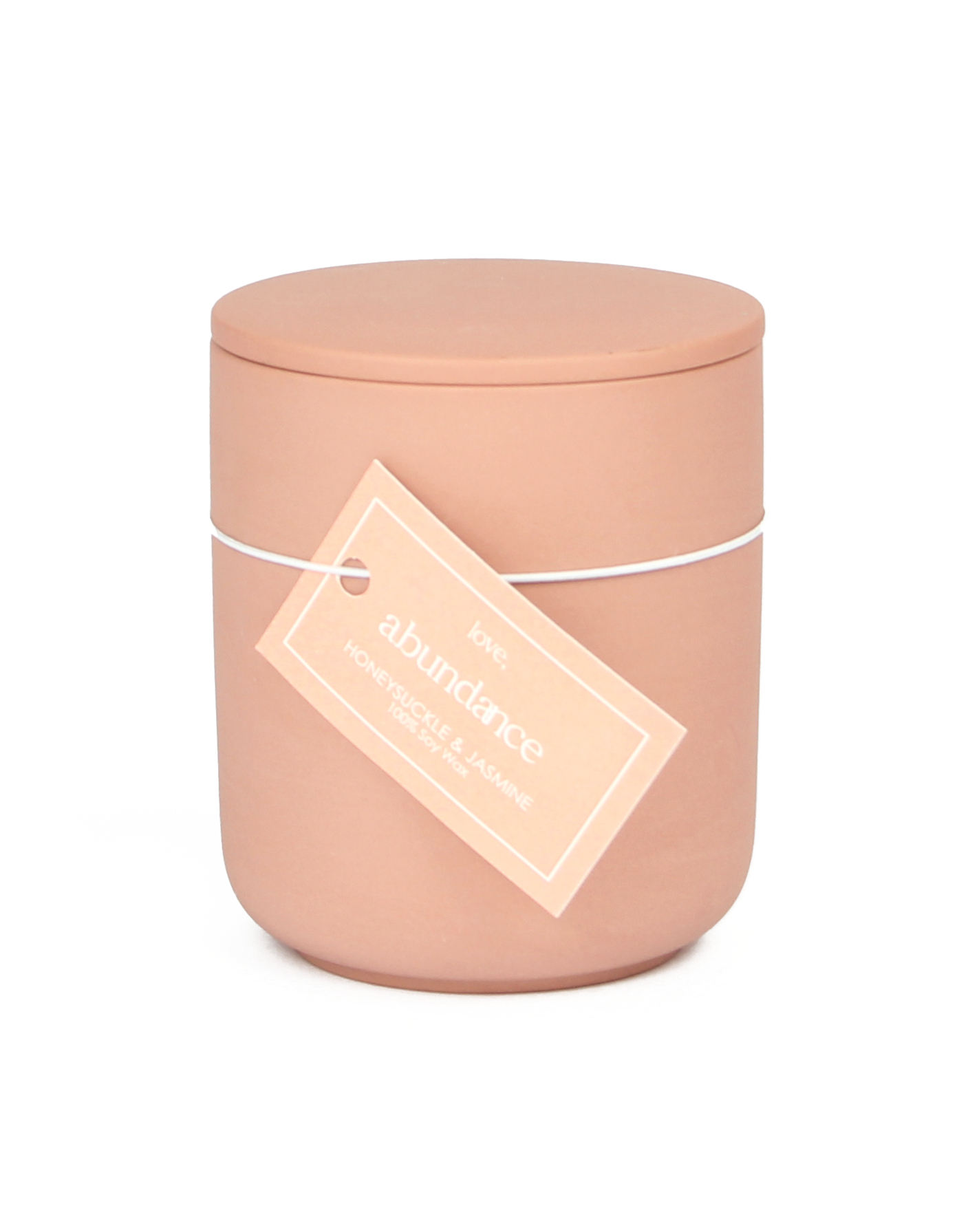 Pink candle with a label on a white background