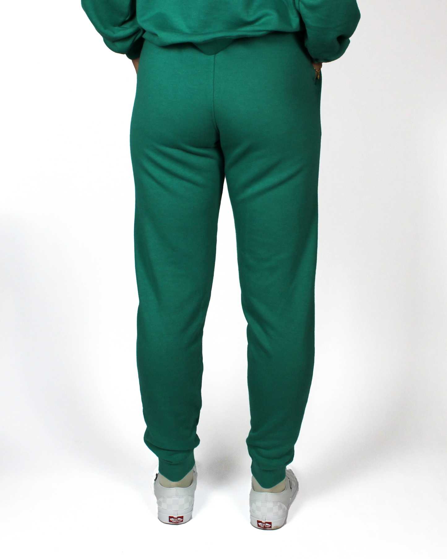 Green tracksuit with white sneakers on a white background