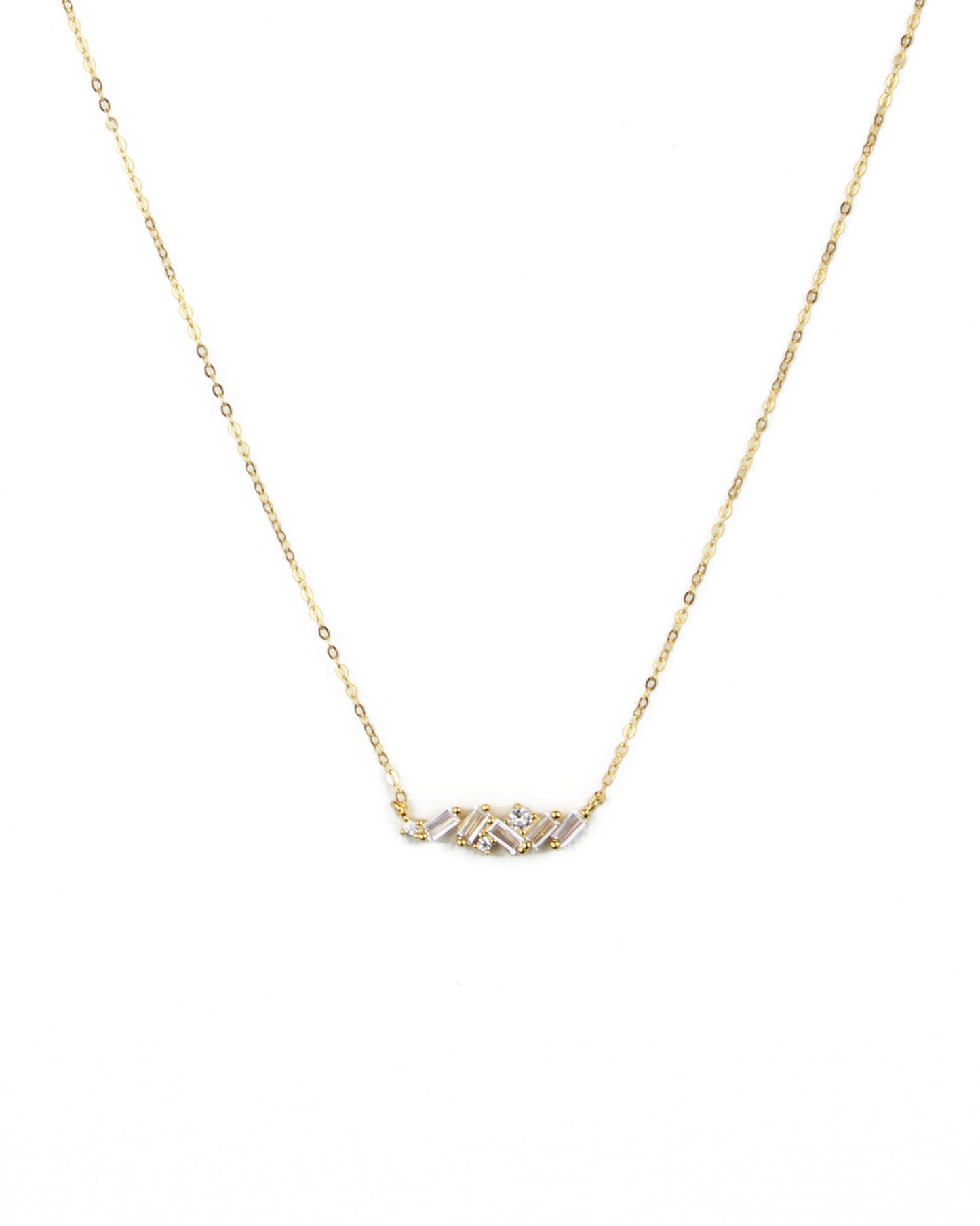 Gold necklace with a small pendant on a white background