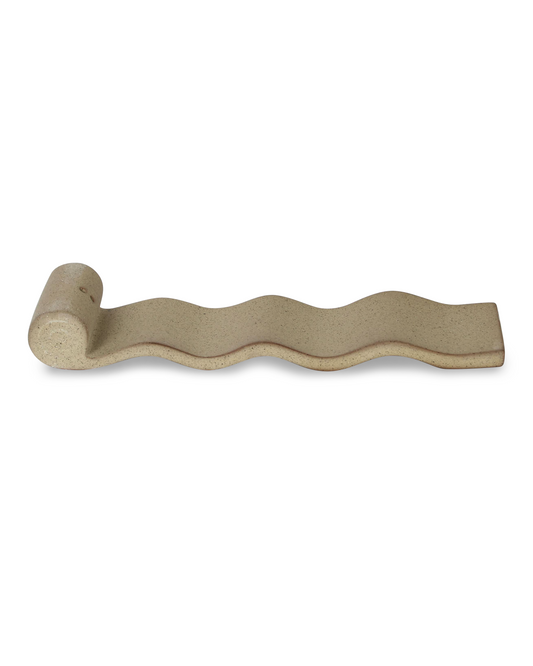 Wavy ceramic incense burner on a white background