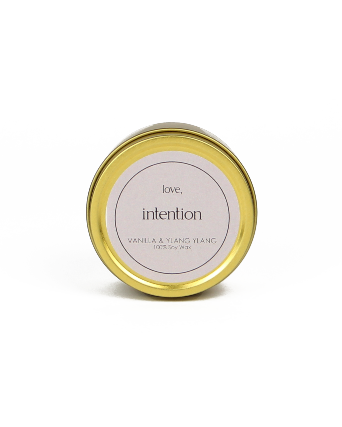 Gold candle jar with a white label on a white background