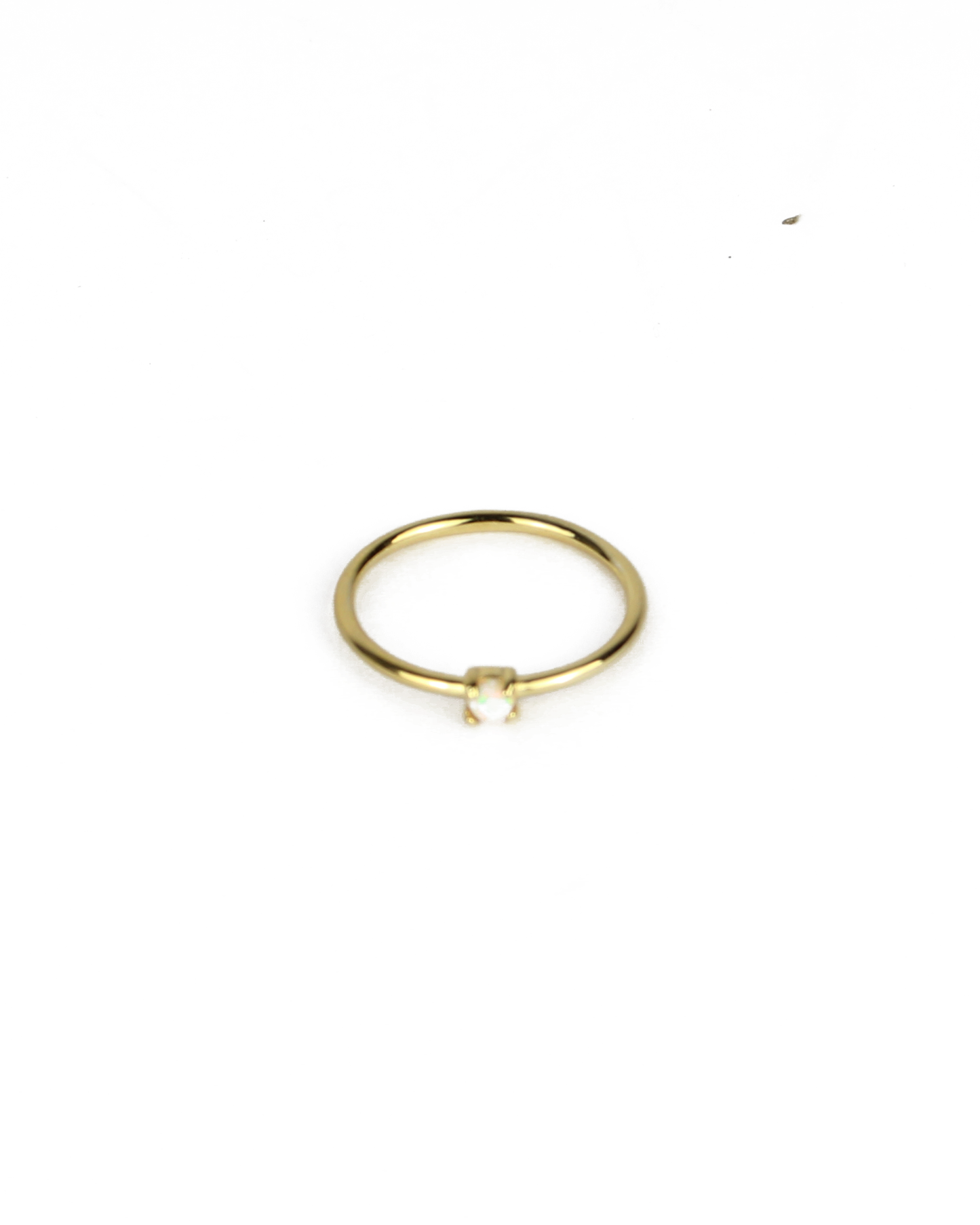 gold ring with opal gemstone on a white background