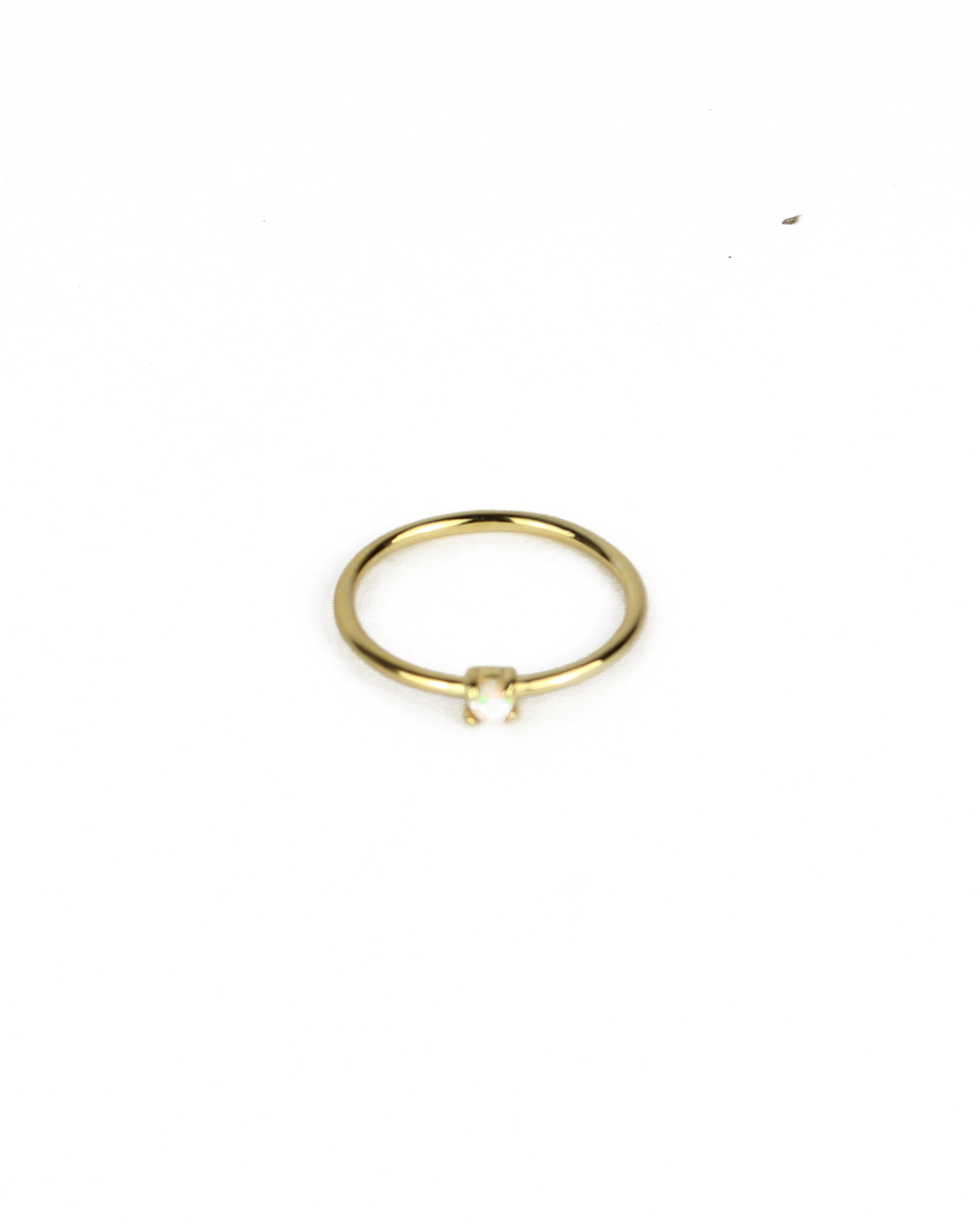 gold ring with opal gemstone on a white background