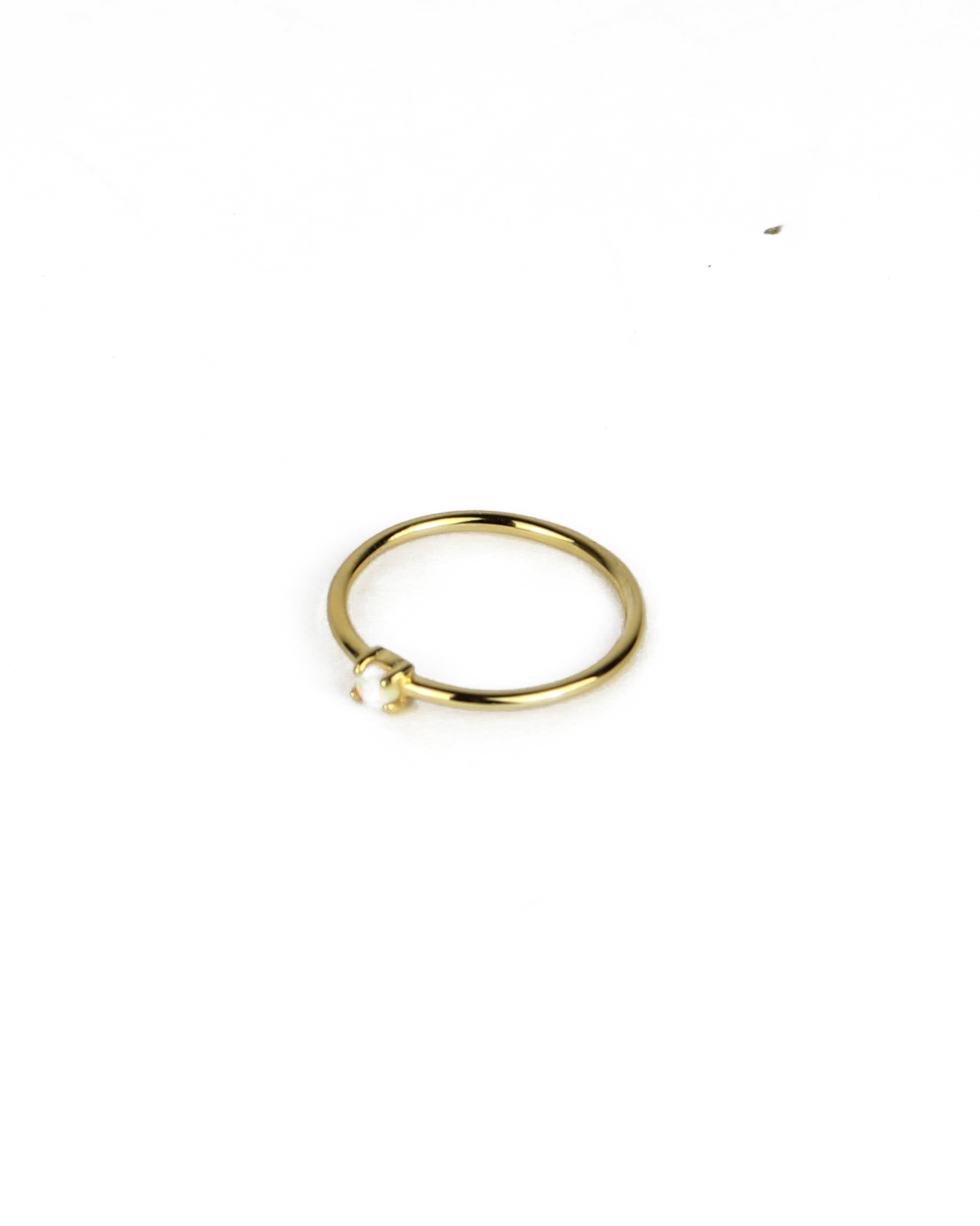 gold ring with opal gemstone on a white background