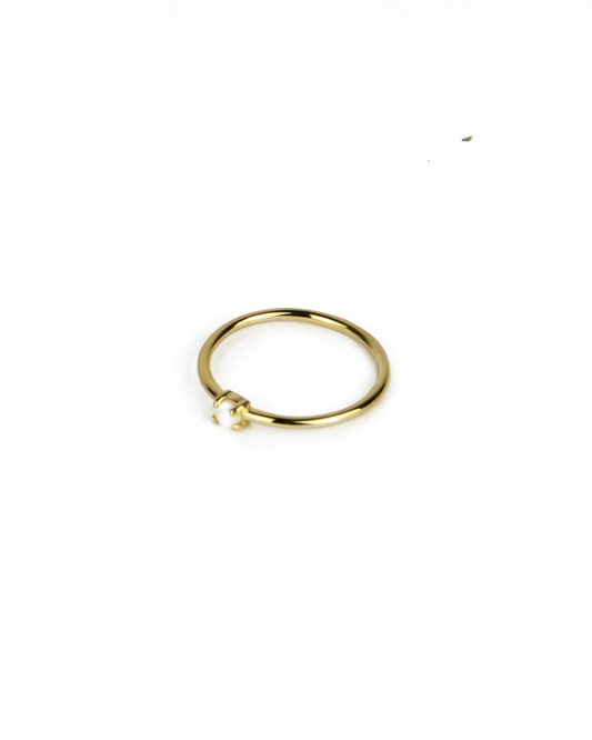 gold ring with opal gemstone on a white background