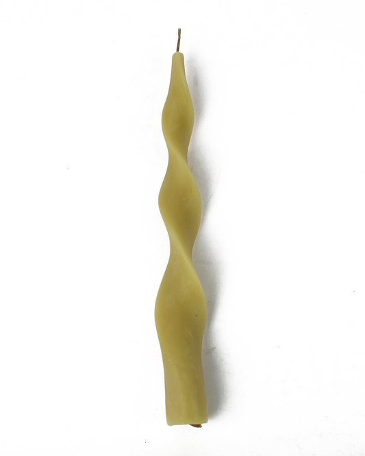 Spiral-shaped yellow candle on a white background