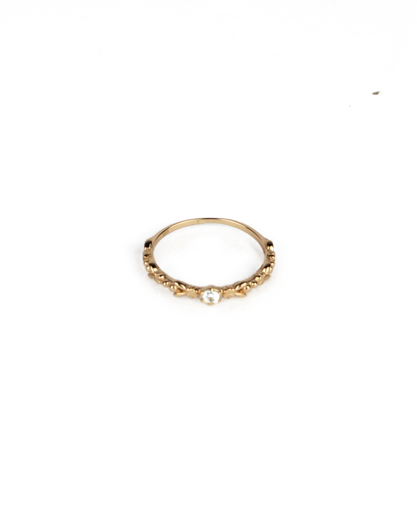 gold ring with gem stone on a white background