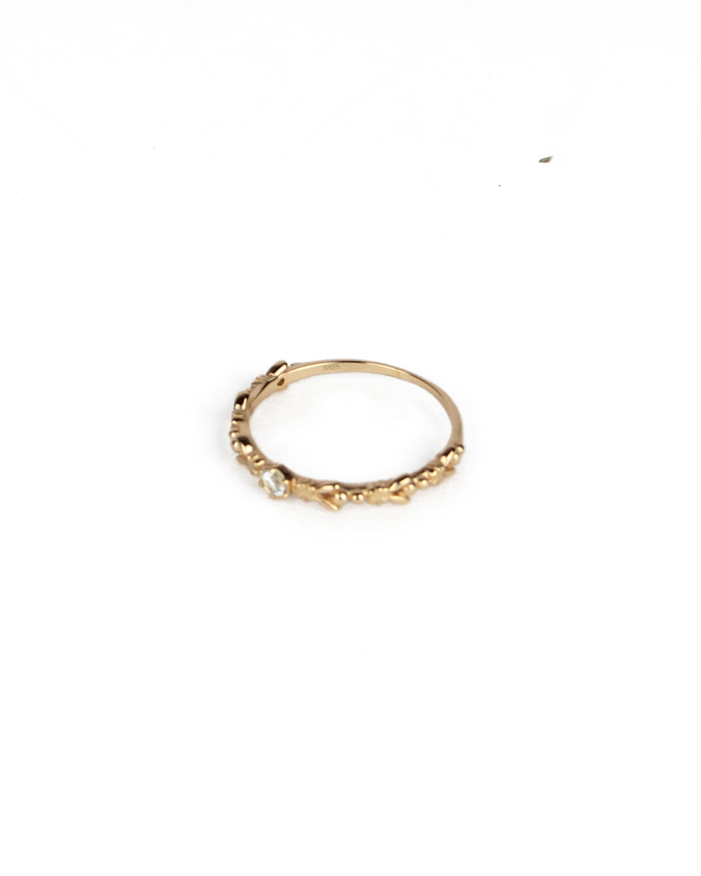 gold ring with gem stone on a white background