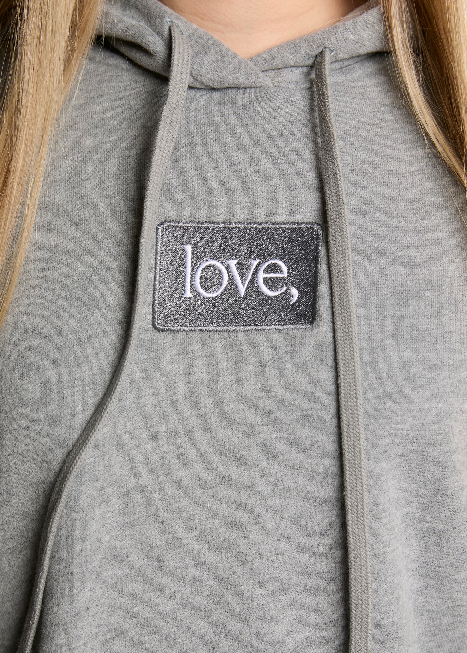 Gray hoodie with a 'love' patch on the chest