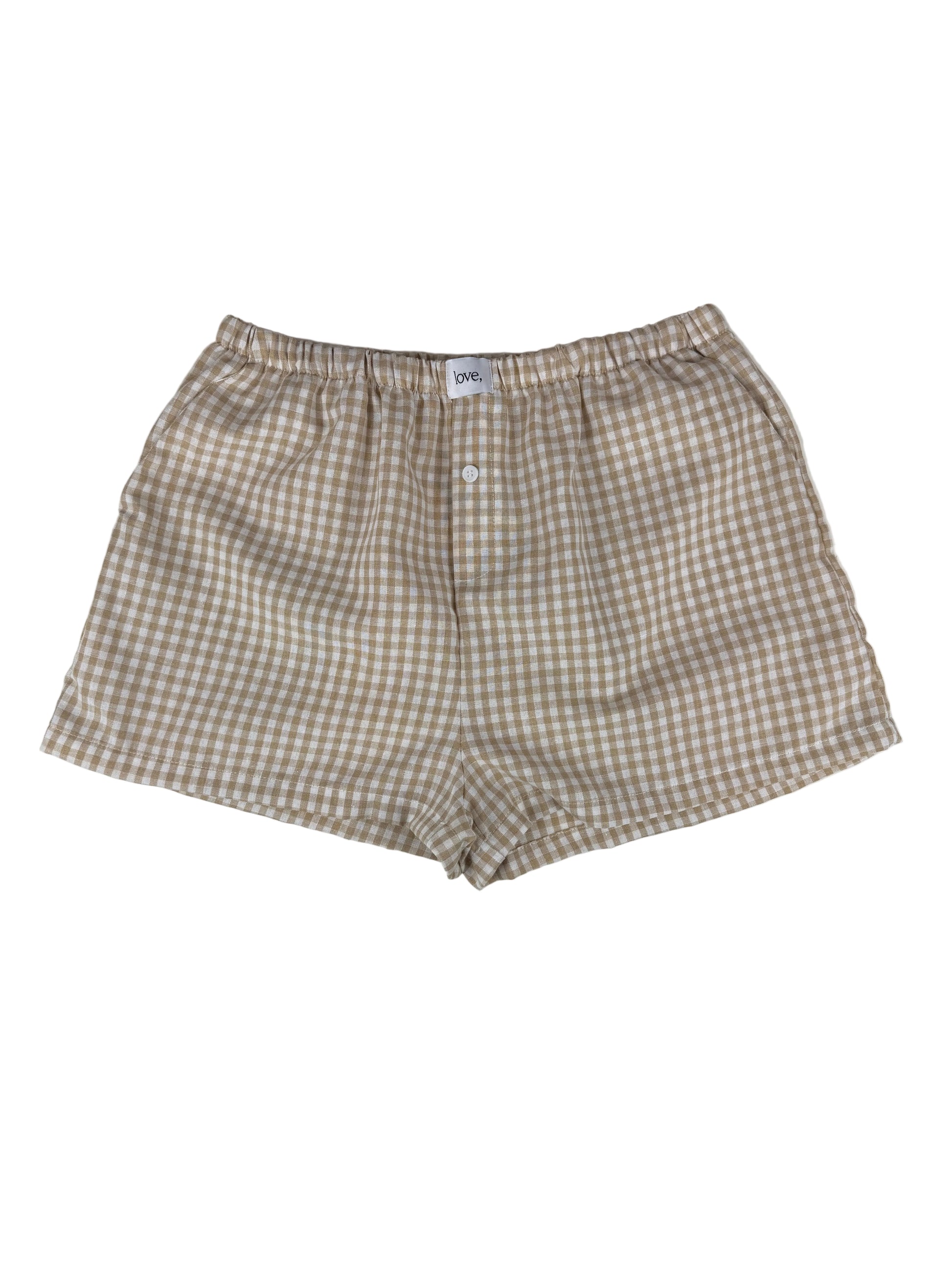khaki and white gingham boxer shorts on a white surface