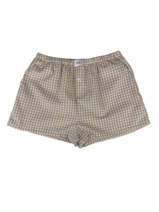 khaki and white gingham boxer shorts on a white surface