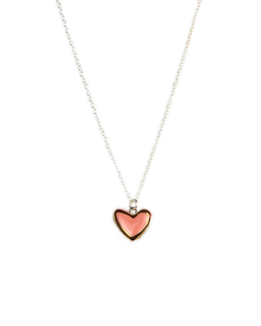 Necklace with a pink heart pendant on a white background