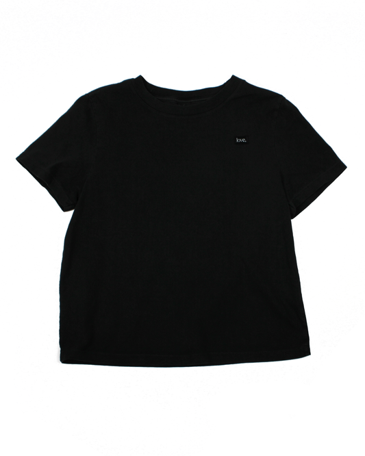 Black t-shirt with a small logo on a white background
