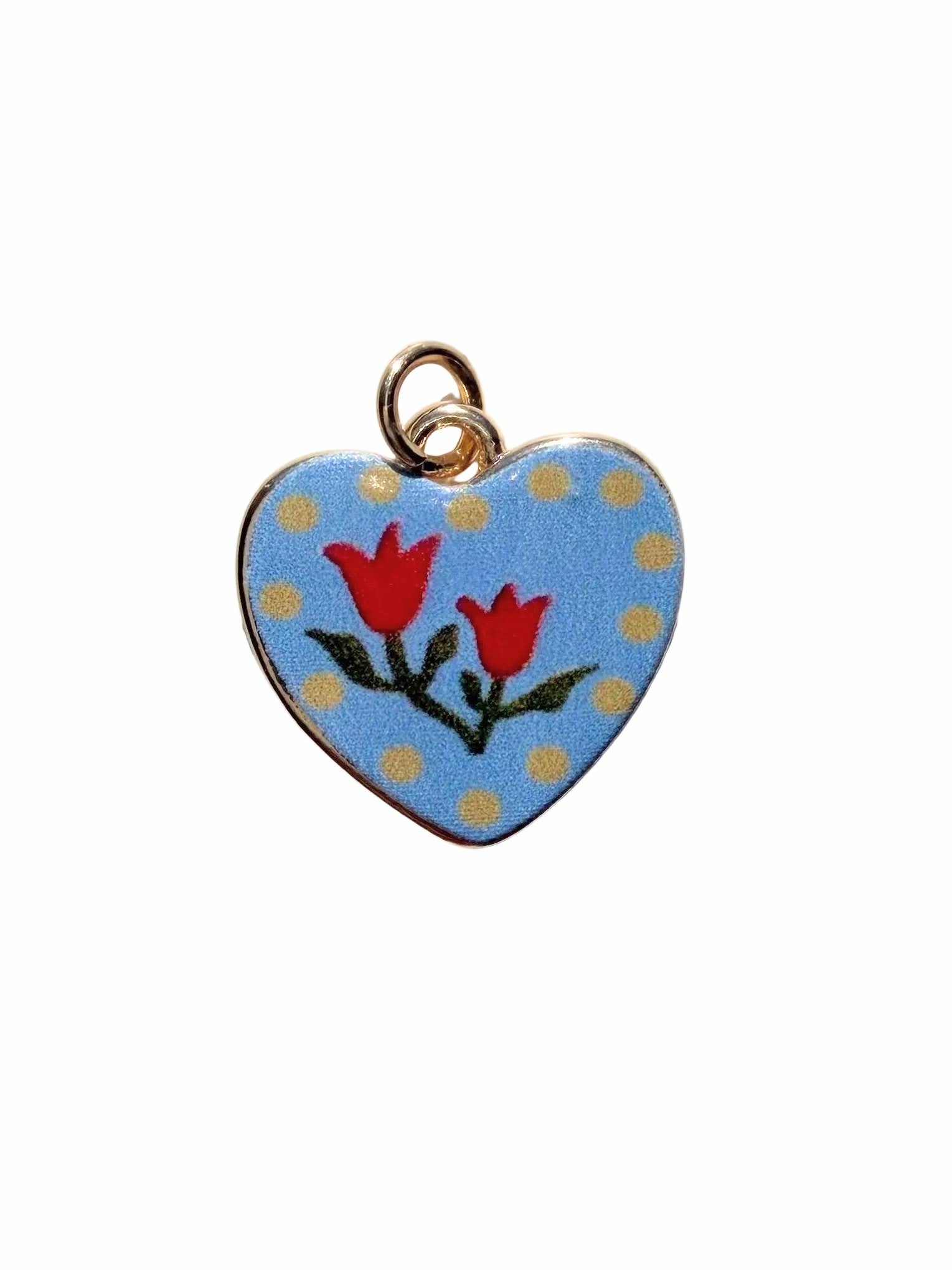 Heart-shaped pendant with red tulips on a blue background with gold polka dots