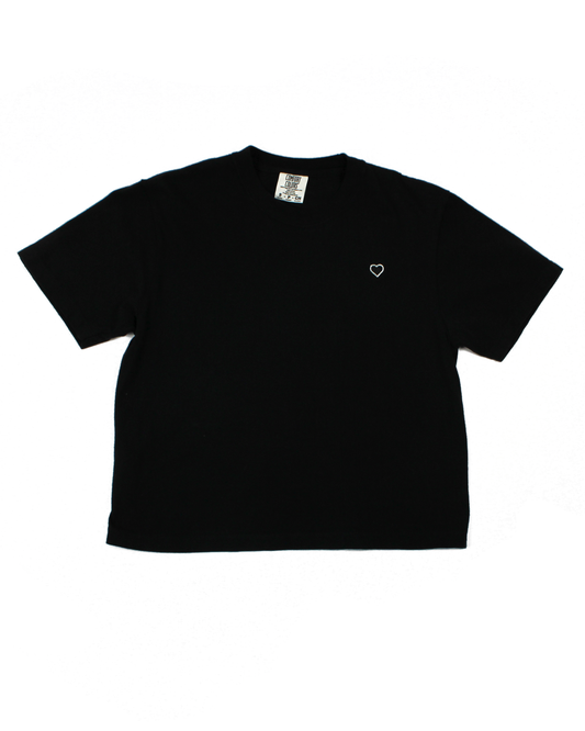 Black tee with a heart patch on a white background