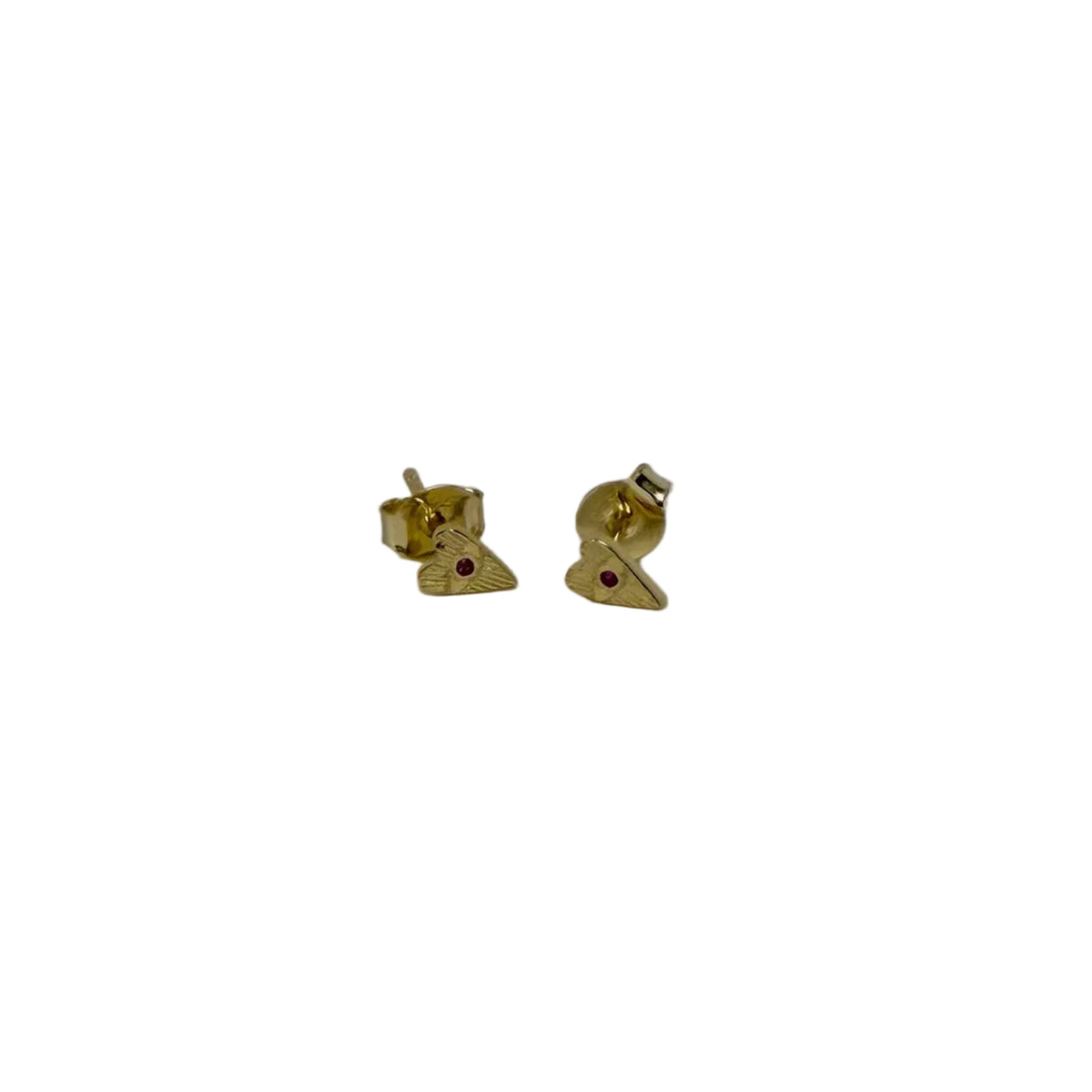 Gold triangle-shaped earrings with a red gemstone on a gray background
