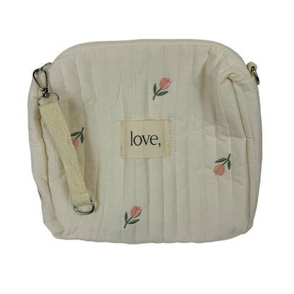 Beige pouch with floral embroidery and 'love' label on a light gray background