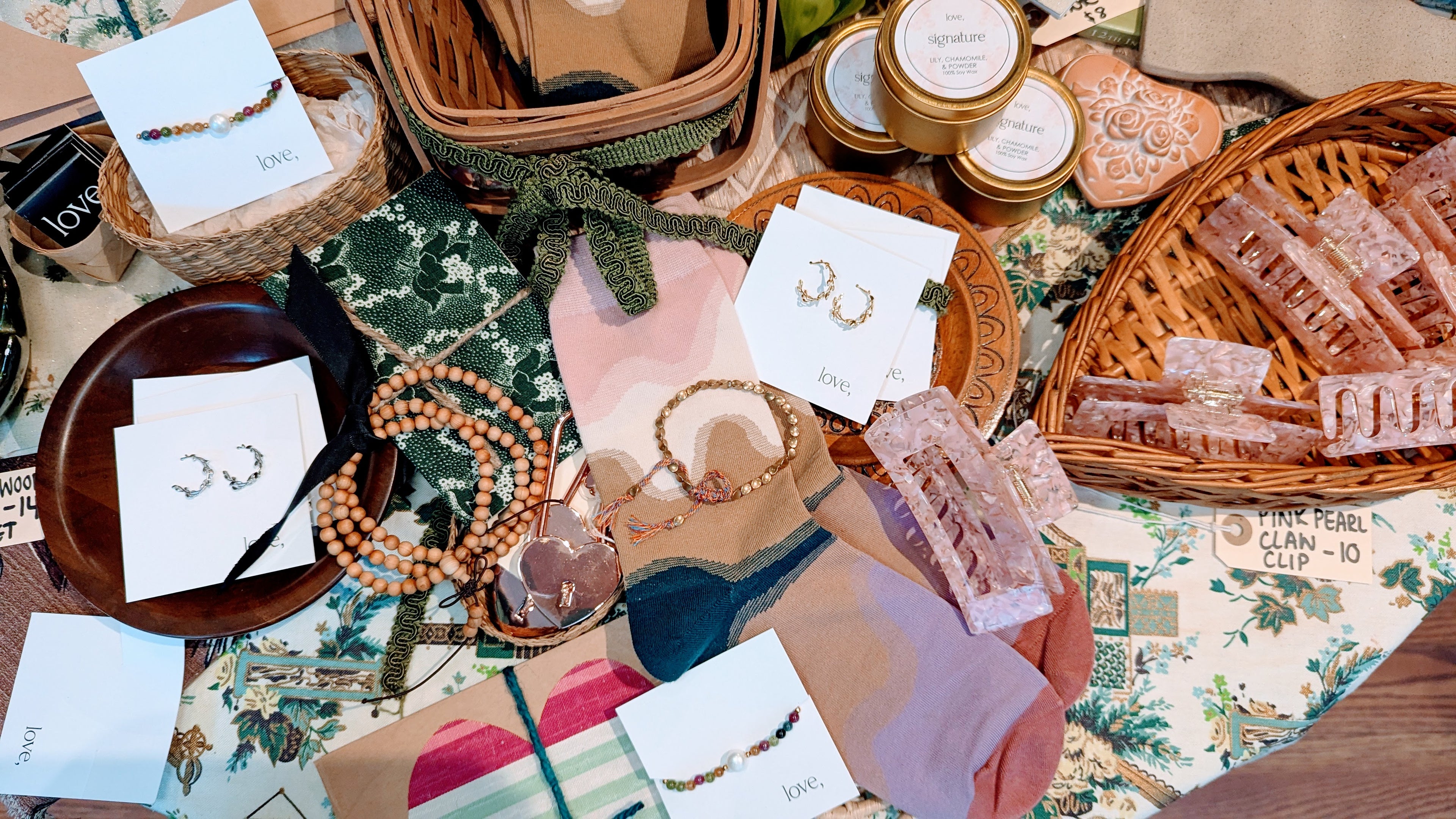 Tabletop display of jewelry and decorative items with a focus on earrings and small containers.