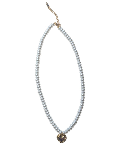 Pearl necklace with a gold heart pendant on a white background