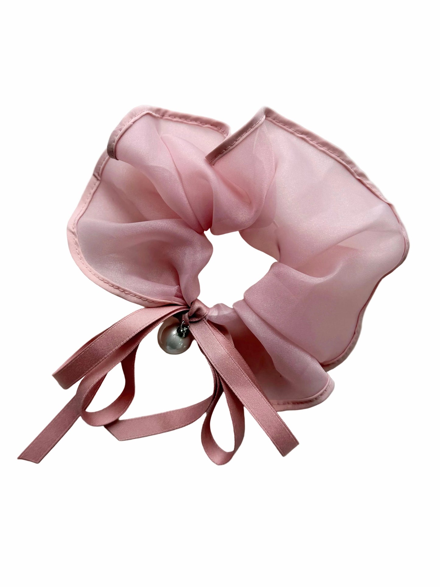 Pink scrunchie with a bow and pearl on a white background