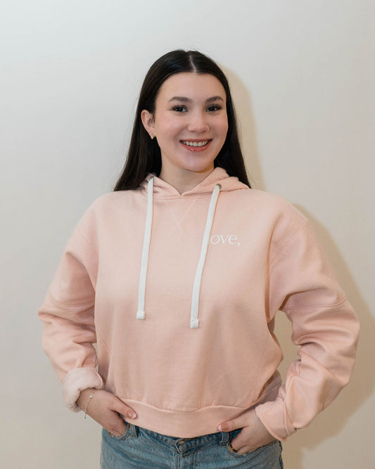 Standard fitting light pink hoodie with white tie in the hood and love printed in white on left chest