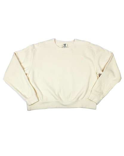 Ivory cream colored crew neck sweatshirt with heart patch on a white background