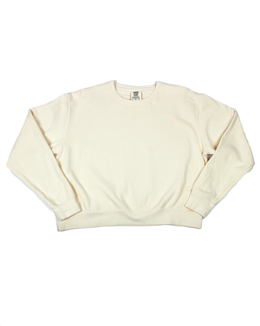Ivory cream colored crew neck sweatshirt with heart patch on a white background