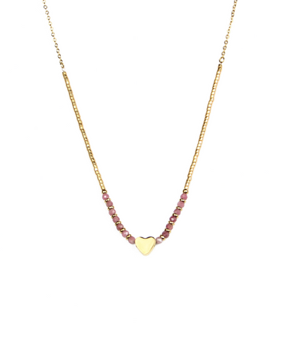Gold necklace with pink beads and a heart charm on a white background