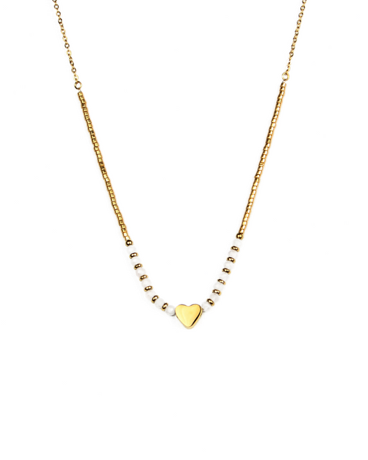 Gold necklace with a heart pendant on a white background