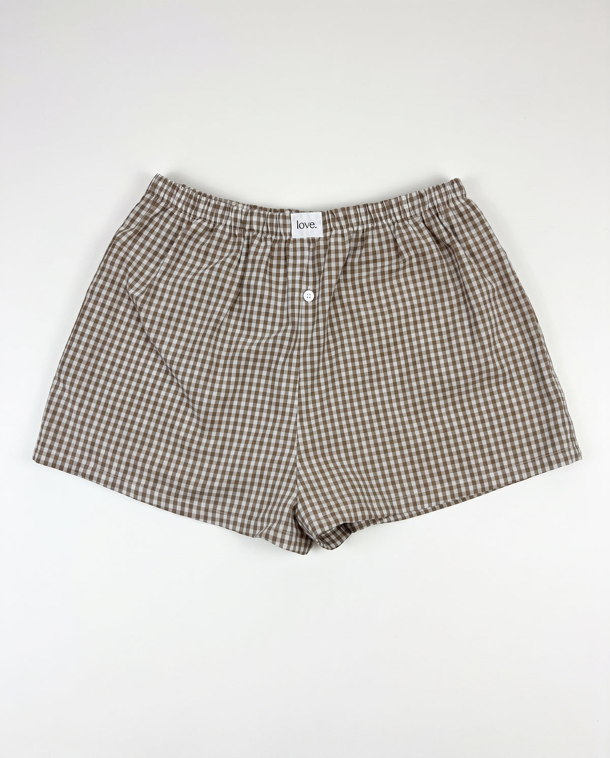 Brown and beige gingham check boxer shorts with an elastic waistband and front button closure, laid flat on a white background.