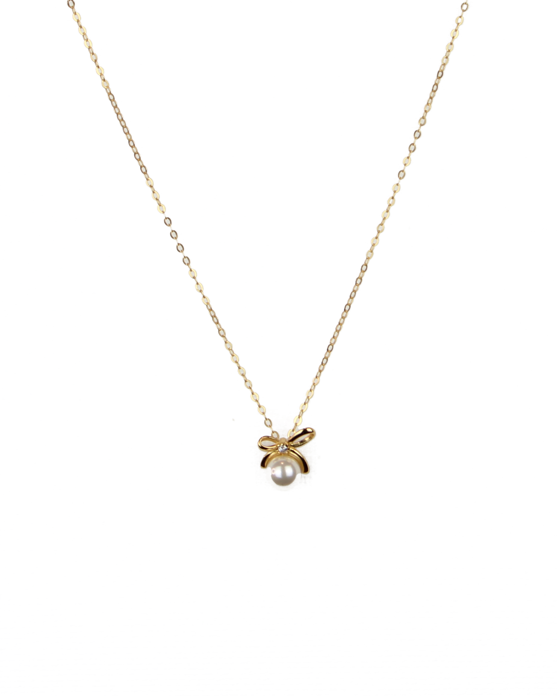 Gold necklace with a small pendant on a white background