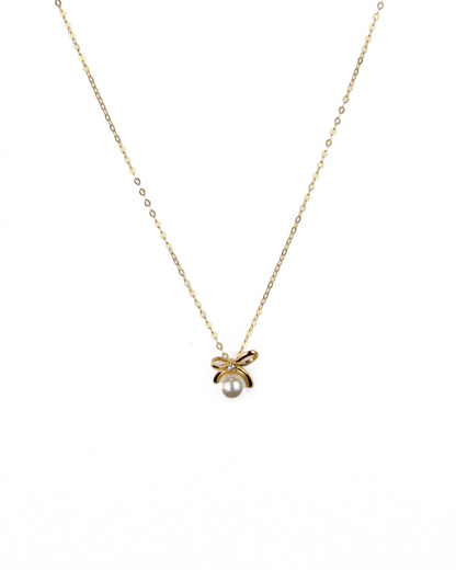 Gold necklace with a small pendant on a white background