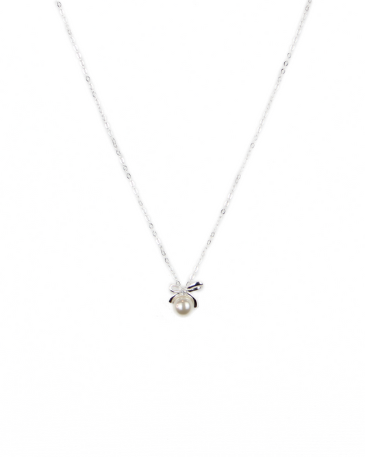 Silver necklace with a small pendant on a white background
