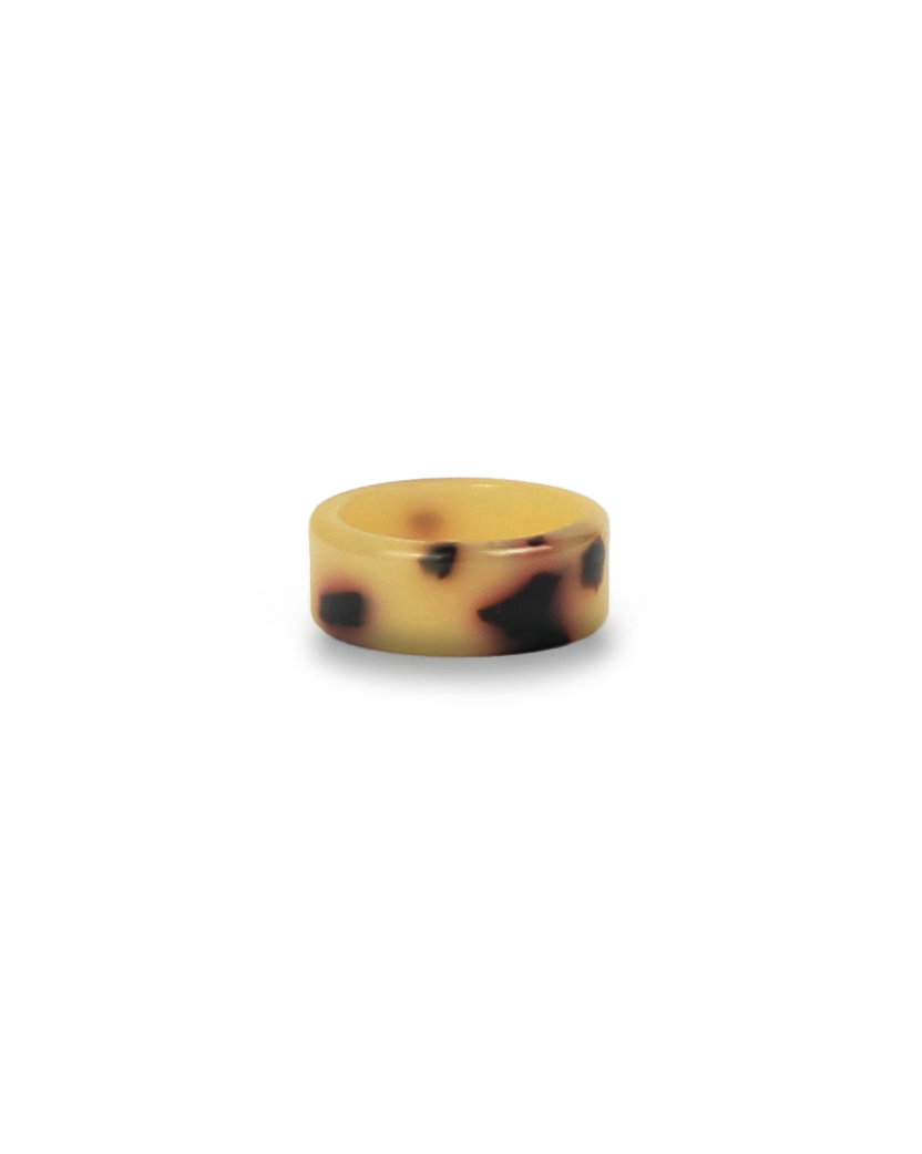Ring with tortoiseshell pattern on a white background