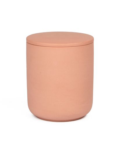 Pink cylindrical container with a lid on a white background