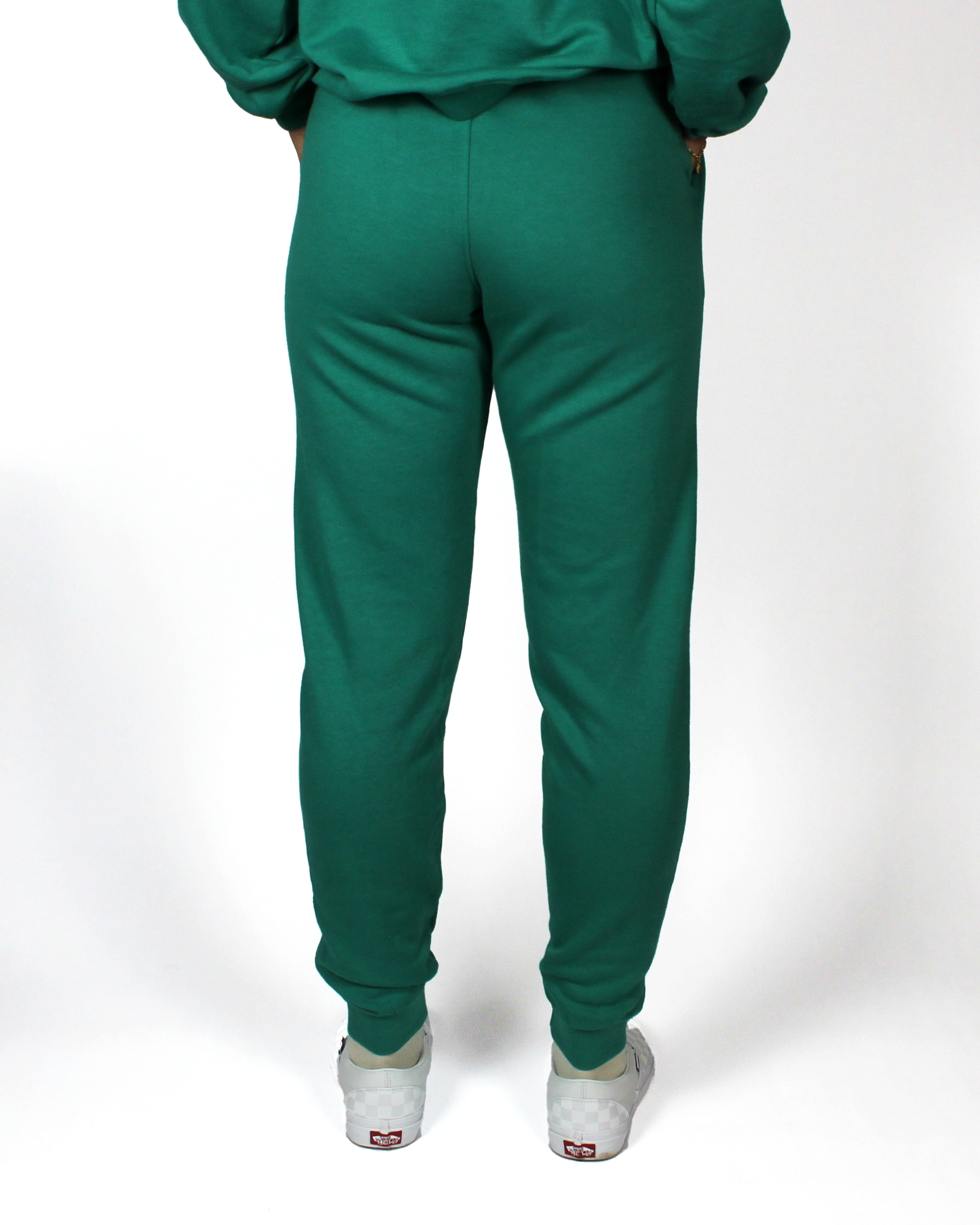Green tracksuit with white sneakers on a white background