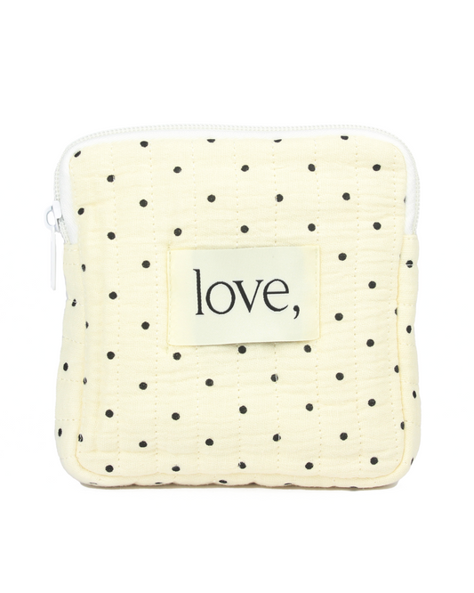 Small pouch with polka dot pattern and 'love' label on a white background