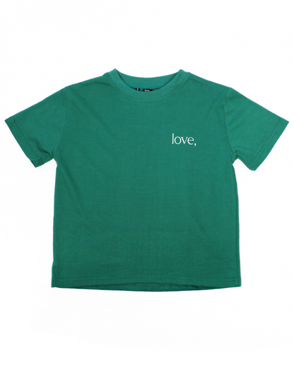 Green t-shirt with 'love,' text on a white background