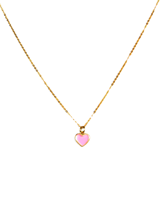 Gold necklace with a pink heart pendant on a white background