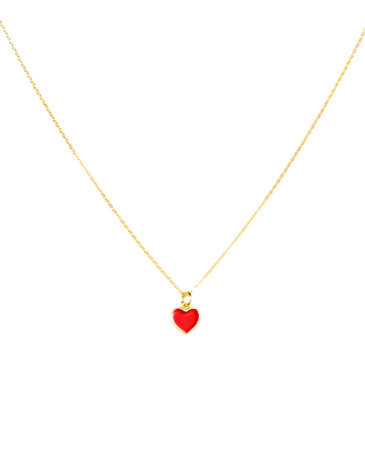 Gold necklace with a red heart pendant on a white background