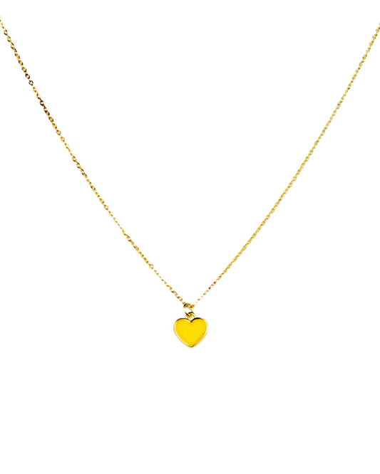 Gold necklace with a heart-shaped pendant on a white background