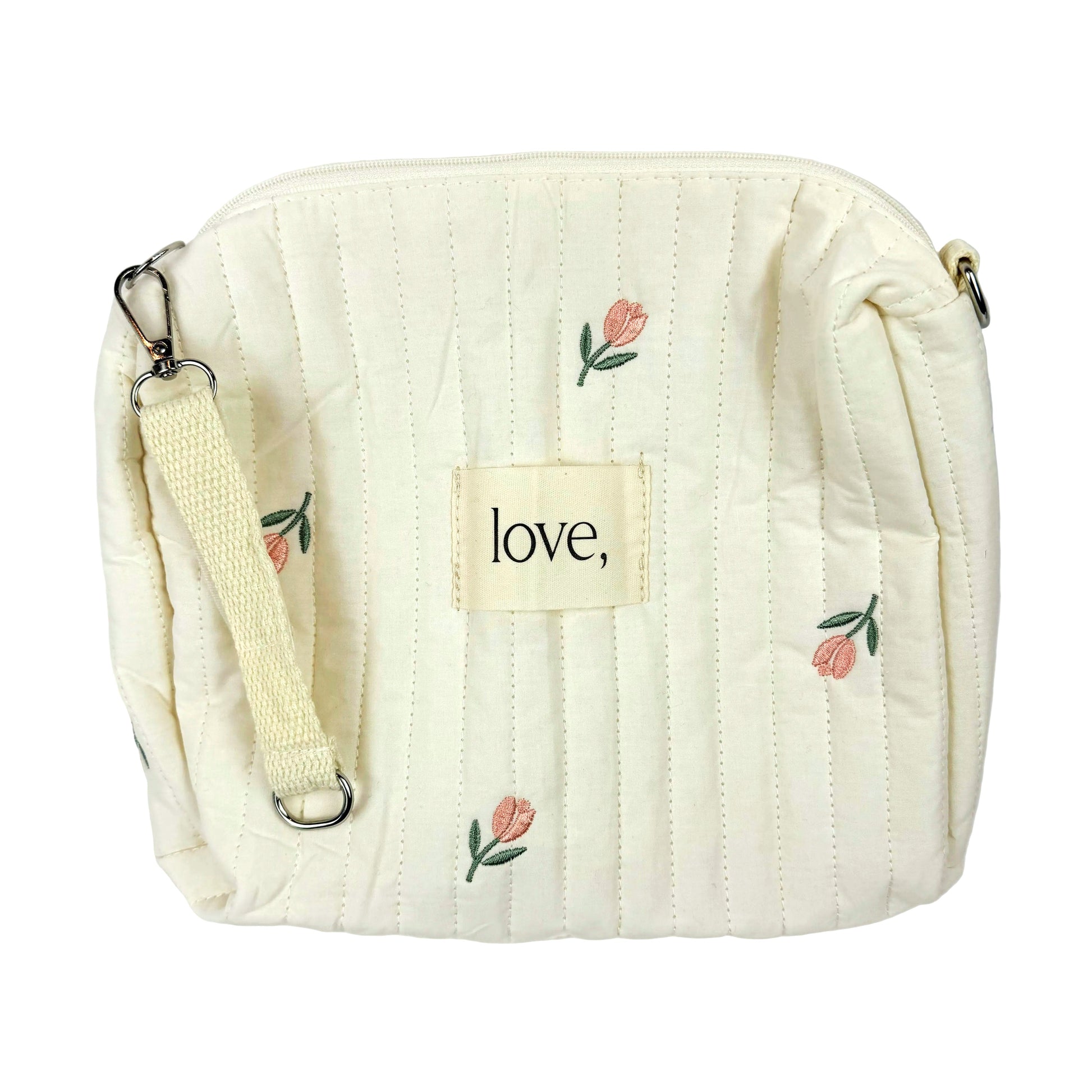 Cream-colored quilted bag with floral embroidery and 'love' tag on a white background