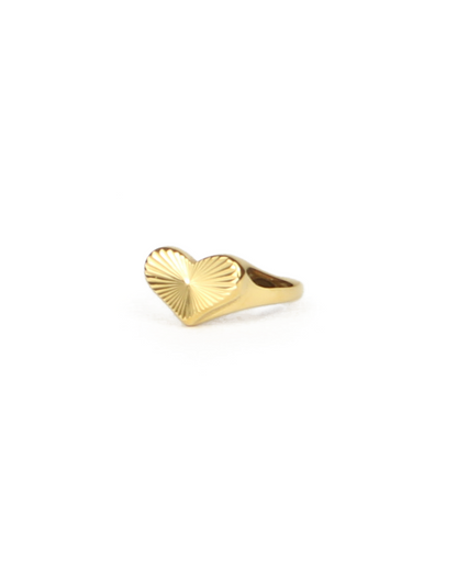 Gold heart-shaped ring on a white background