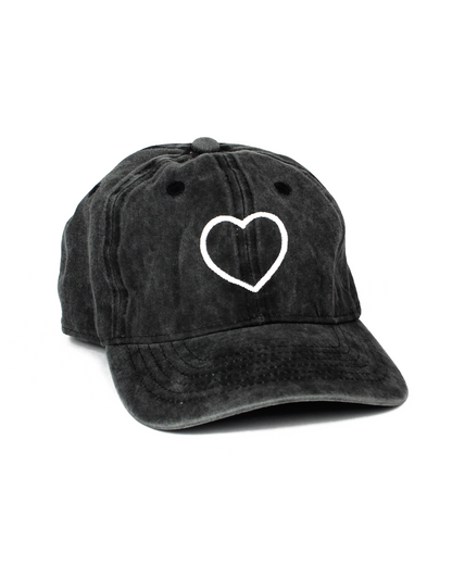 Black cap with a white heart design on a white background