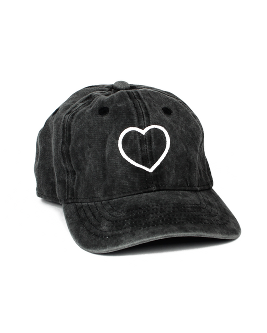Black cap with a white heart design on a white background