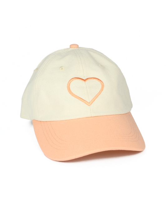 Two-toned cap with a heart design on a white background
