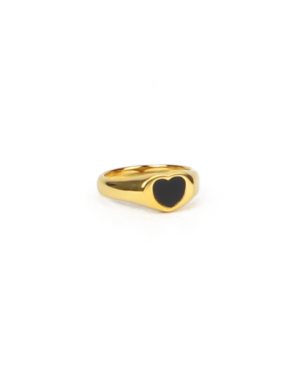 Gold ring with a black heart-shaped enamel on a white background