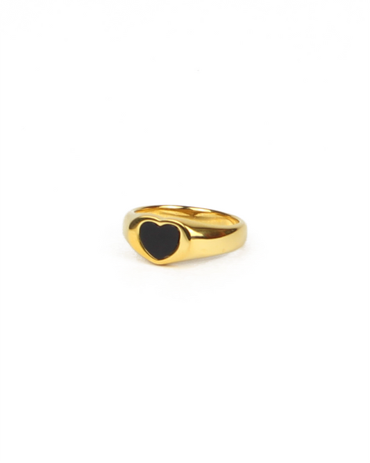 Gold ring with a black heart-shaped enamel on a white background